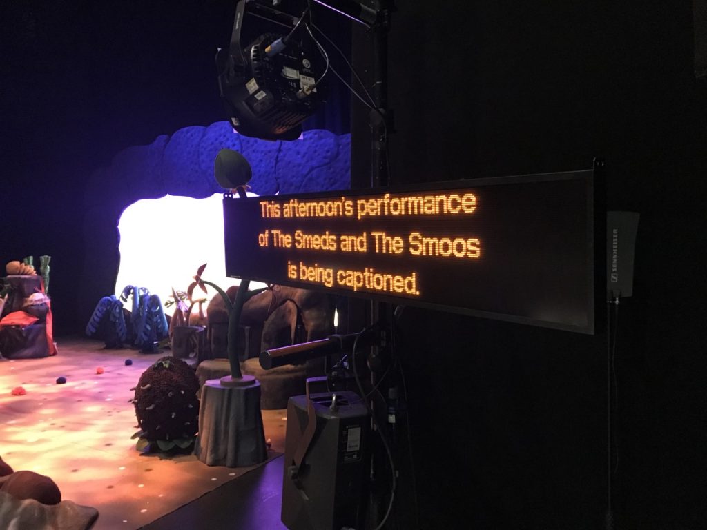 image of a performance with captions - to make it more accessible